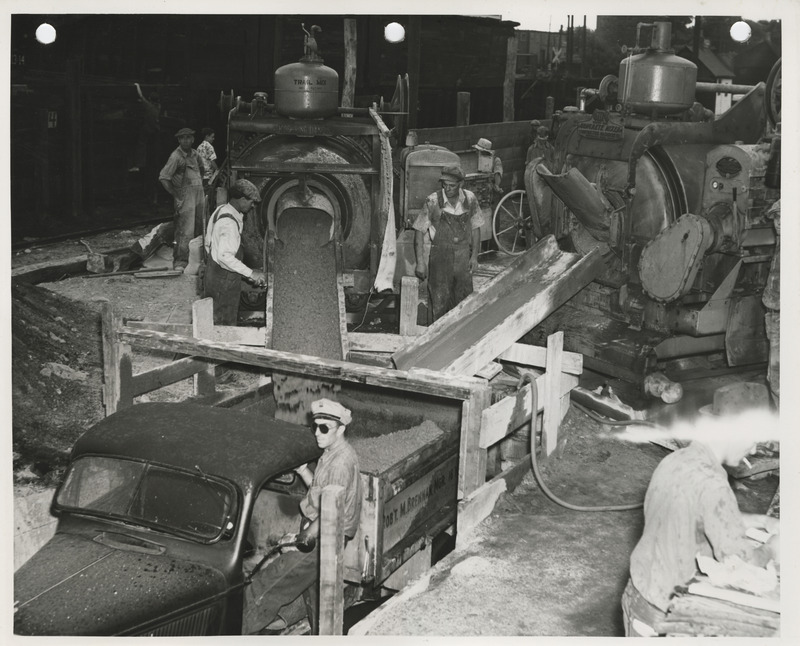 Photograph of people working at the concrete mixing plant for street paving in Fort Dodge