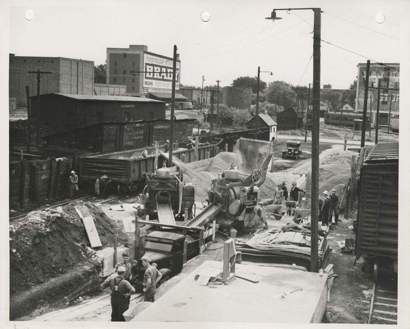 Photograph of people working at the concrete mixing plant for street paving in Fort Dodge
