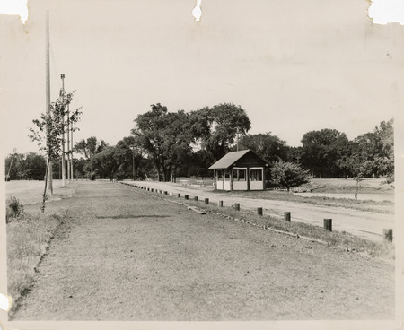 Photograph of a shelter house and a section of cinder track that encircles the ball field in Washington Park