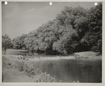 Photograph of the rock and log crib dam on the Winnebago River in Winnebago county
