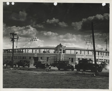 Photograph of cars parked outside the completed stadium in Clinton