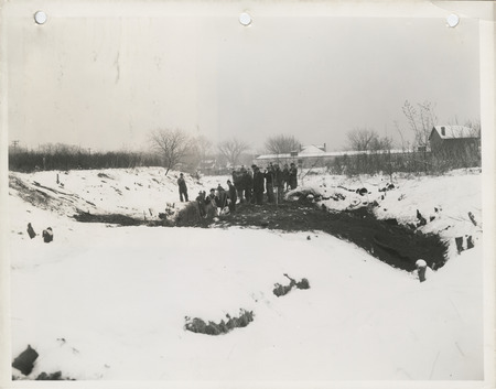 Photograph of people constructing a storm drain at 13th ave. and 4th st. in Clinton