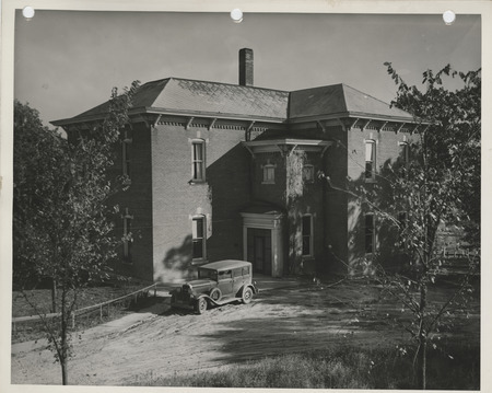Photograph of a car parked outside the community house in Columbus Junction