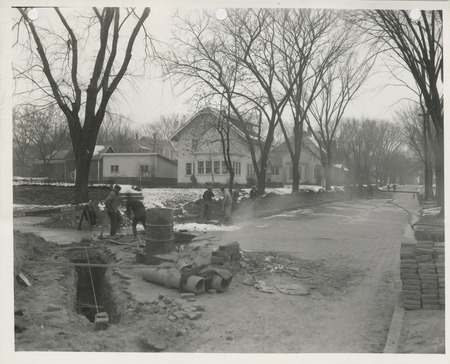 Photograph of people working on a sewer in Muscatine