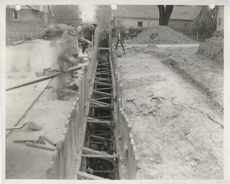Photograph of people working on an interceptor sewer at Steuben Avenue and 18th Street in Davenport