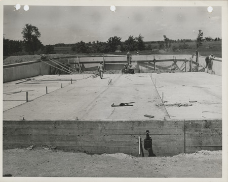 Photograph of people working on a swimming pool in Adel