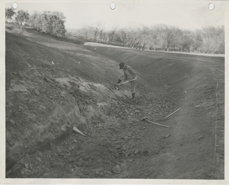 Photograph of a person working on a ditch in Guthrie County