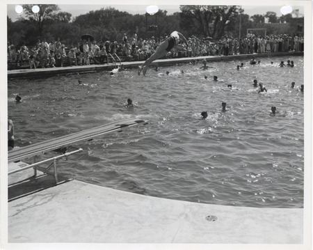 Photograph of people at the diving board and swimming pool at Edmundson Park in Oskaloosa