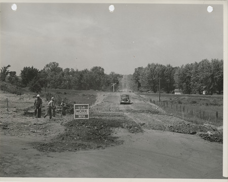 Photograph of grading a road at a railroad crossing in Flagler