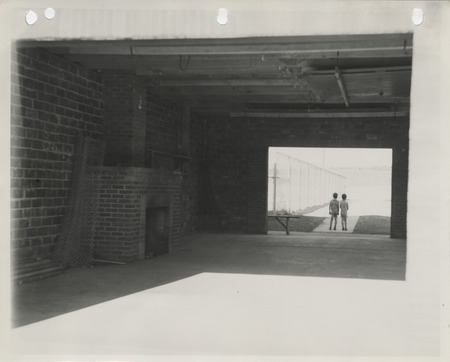 Photograph of two people standing outside a shelter house at a city park in Pella