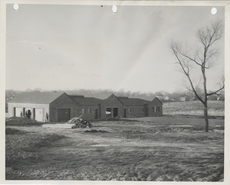 Photograph of people constructing the swimming pool and bathhouse at a city park in Pella