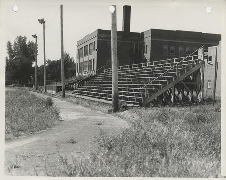 Photograph of a running track and rebuilt bleachers at a high school in Albia