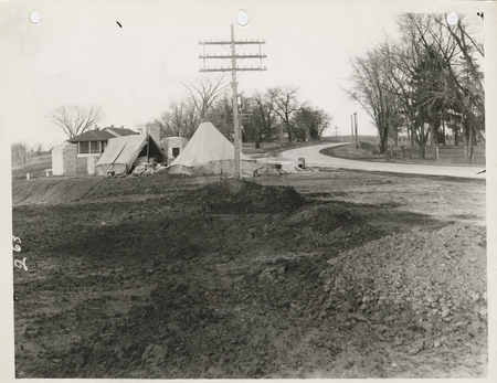 Photograph of the construction of a stone fence at Camp Dodge