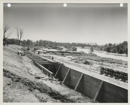 Photograph of the construction of a river wall in Des Moines