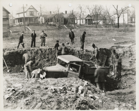 Photograph of people cutting down a hill at W 2nd and Bluff in Des Moines