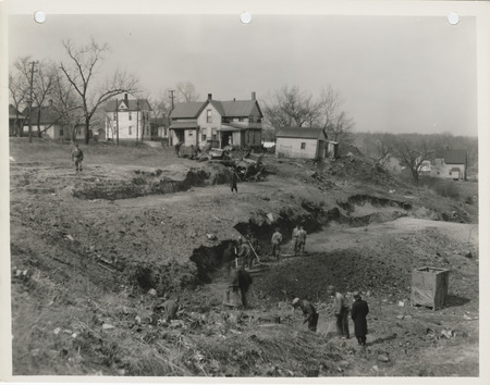 Photograph of people cutting down a hill at W 2nd and Bluff in Des Moines