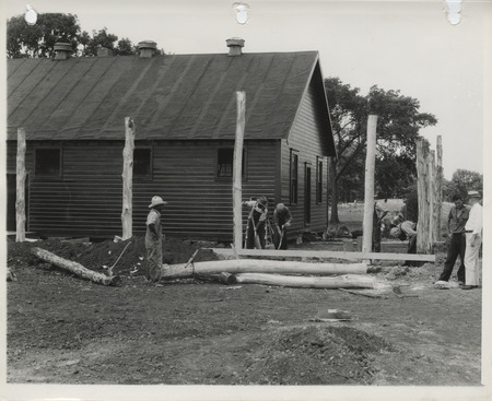 Photograph of people remodeling an old building into a clubhouse for the college golf course in Ames