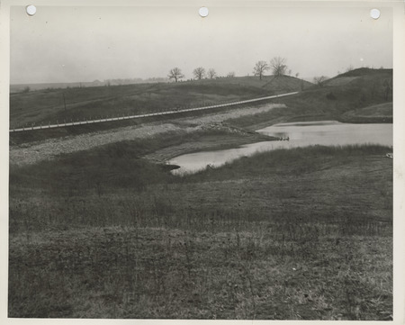 Photograph of reservoir dam and riprap along the highway in Afton
