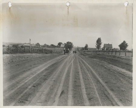 Photograph of individuals raiding horse carts in the farm-to-market road in Wayne County
