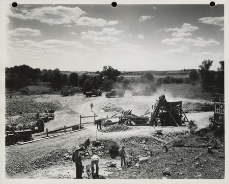 Photograph of men working at the quarry using crusher in Lewis