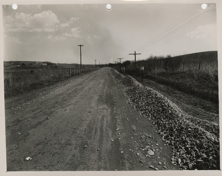 Photograph of farm-to-market road surfacing with crushed rock in Council Bluffs