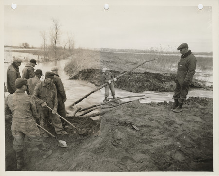 Photograph of people repairing a broken dike at Lake Manawa in Council Bluffs