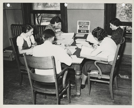 Photograph of people surveying farm records in Spencer