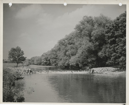 Photograph of a rock and log crib dam on the Winnebago River in Winnebago County