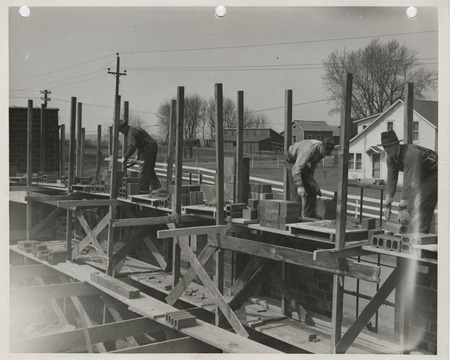 Photograph of people constructing a maintenance garage in Boone