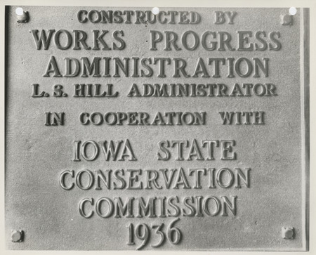 Photograph of the metal plaque placed on the completed sea wall