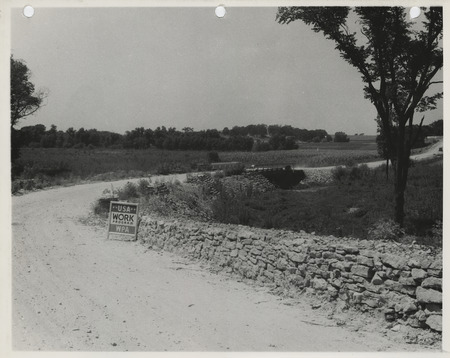 Photograph of guard rails and riprapped bridge along the farm-to-market road in Cedar Rapids