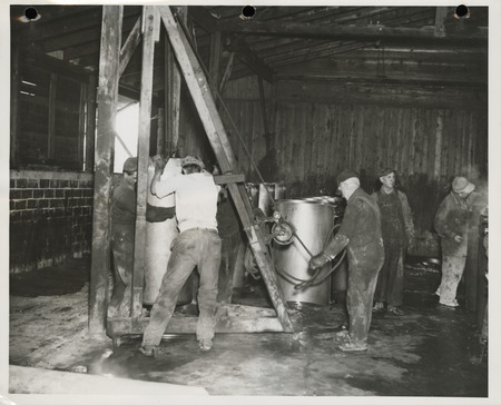 Photograph of men working at the cement tile plant in Marshalltown to build farm-to-market roads