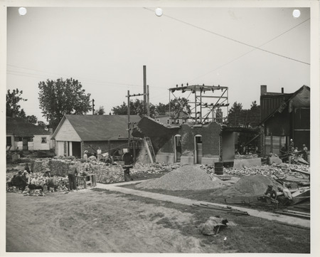 Photograph of people razing the power plant prior to reconstruction in West Liberty