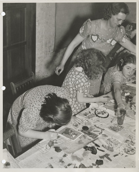 Photograph of people painting plaques in Muscatine