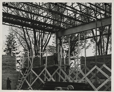 Photograph of people working on a school building gymnasium addition in Durant