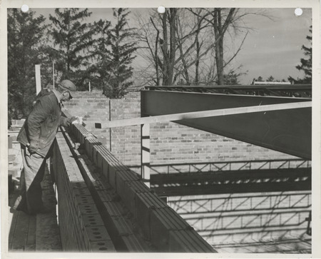 Photograph of people working on a school building gymnasium addition in Durant