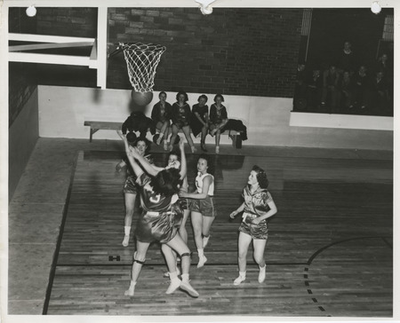 Photograph of a basketball game at a school gymnasium in Weldon