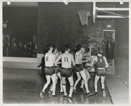 Photograph of a basketball game at a school gymnasium in Weldon