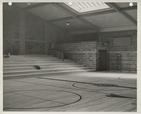 Photograph of school building gymnasium bleacher construction in Colfax