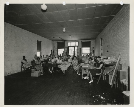 Photograph of people in a sewing room in Mason City