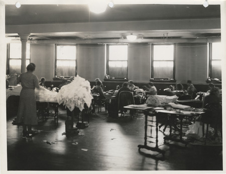 Photograph of people in a sewing room in Clinton