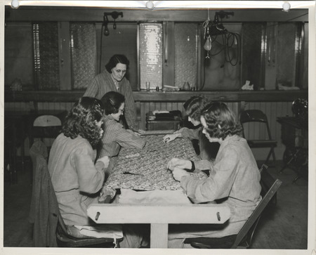 Photograph of people making quilts in a sewing room in Dubuque