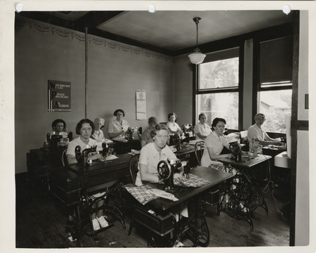 Photograph of people in a sewing room in Charles City