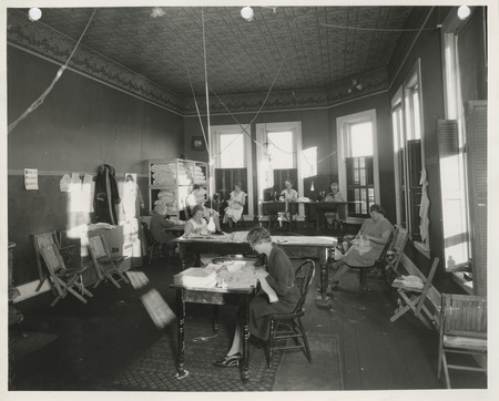 Photograph of people in a sewing room in Glenwood