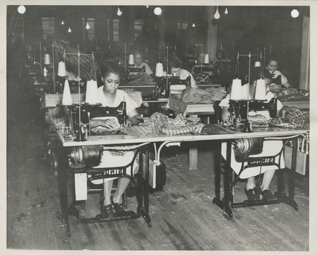 Photograph of women sewing in the sewing room in Davenport