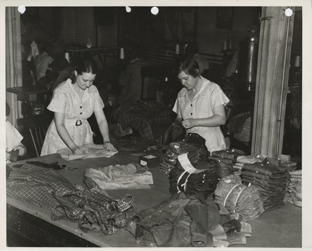 Photograph of women sorting the garments in the sewing room in Davenport
