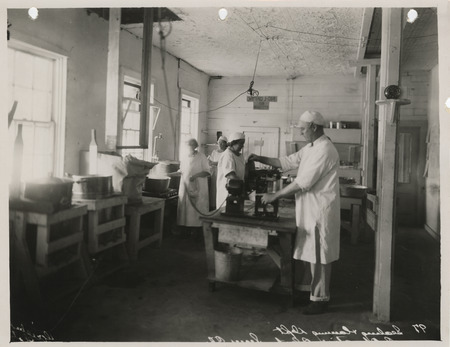 Photograph of people canning cherries at the co-operative plant in Sioux City