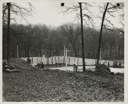 Photograph of people wrecking old swimming pool in Centerville