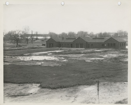 Photograph of the swimming pool and the bathhouse under construction at the city park in Pella.