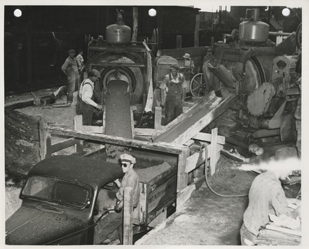 Photograph of people working at the concrete mixing plant for street paving in Fort Dodge
